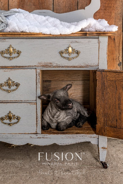 Fusion Mineral Paint | Small lamb sitting in door of baby changing table painted with little lamb.