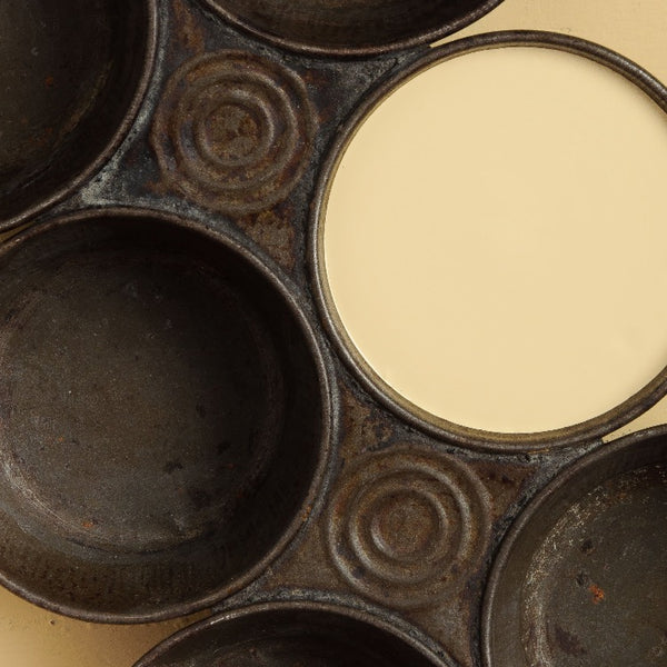 Fusion Mineral Paint | One Metal muffin tin filled with paint on a Buttermilk cream painted background.