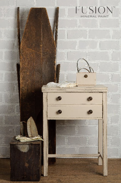 Fusion Mineral Paint | Cathedral Taupe painted dresser with other decor along grey brick wall