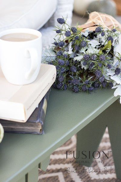 Fusion Mineral Paint | French Eggshell painted table with books and a bouquet of flowers on top.