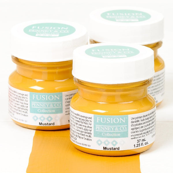 Fusion Mineral Paint | Three small jars of Mustard on a white background with a paint streak down the middle.