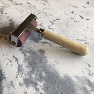 Iron Orchid Design | Brayer on a marble countertop.
