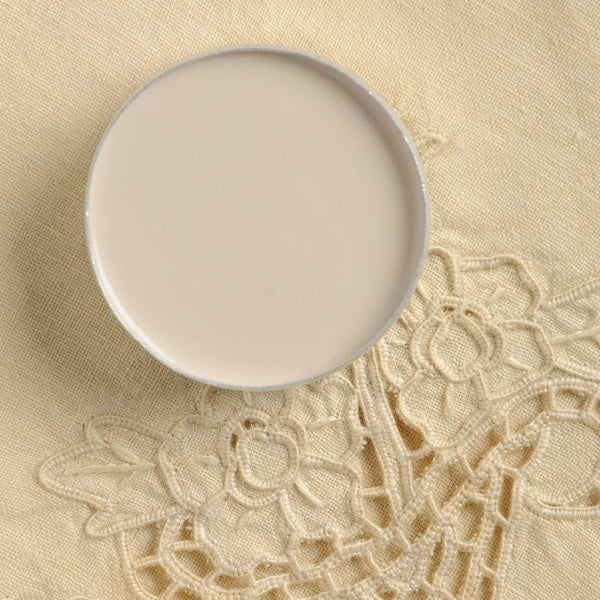 Fusion Mineral Paint | Bowl with paint inside on lace tablecloth background.