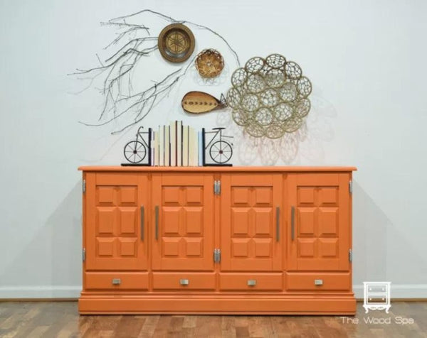 Fusion Mineral Paint | Tuscan Orange painted dresser in front of a white wall with other decor.