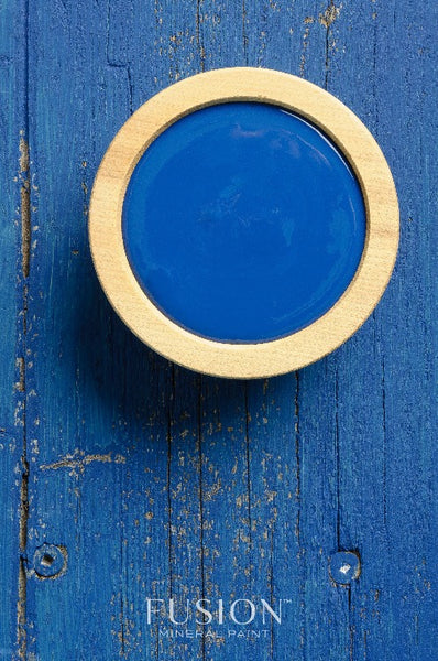 Fusion Mineral Paint | Liberty Blue painted background with a wooden bowl filled with paint.