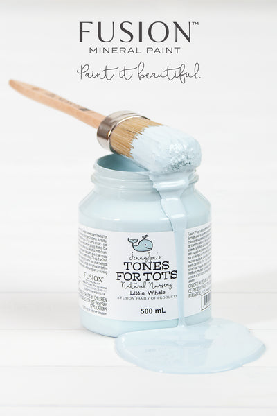 Fusion Mineral Paint | Little Whale paint jar with paintbrush sitting on top dripping paint.